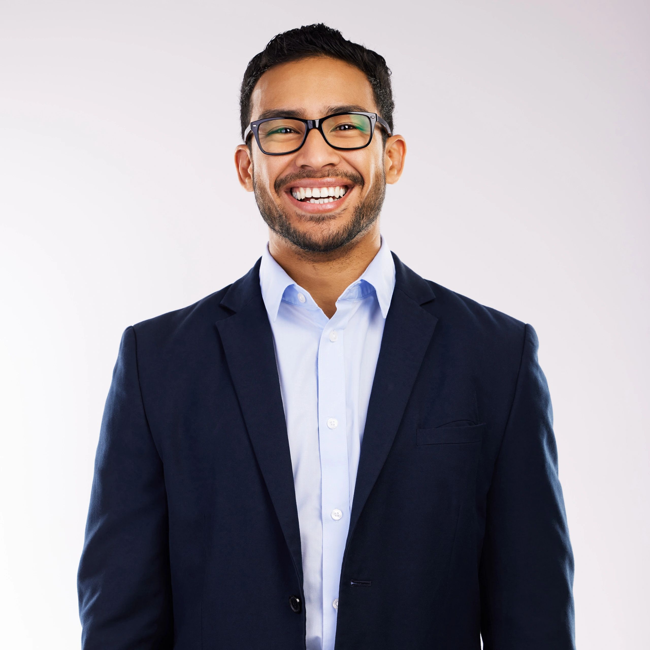 Professional headshot of a smiling man on a neutral background