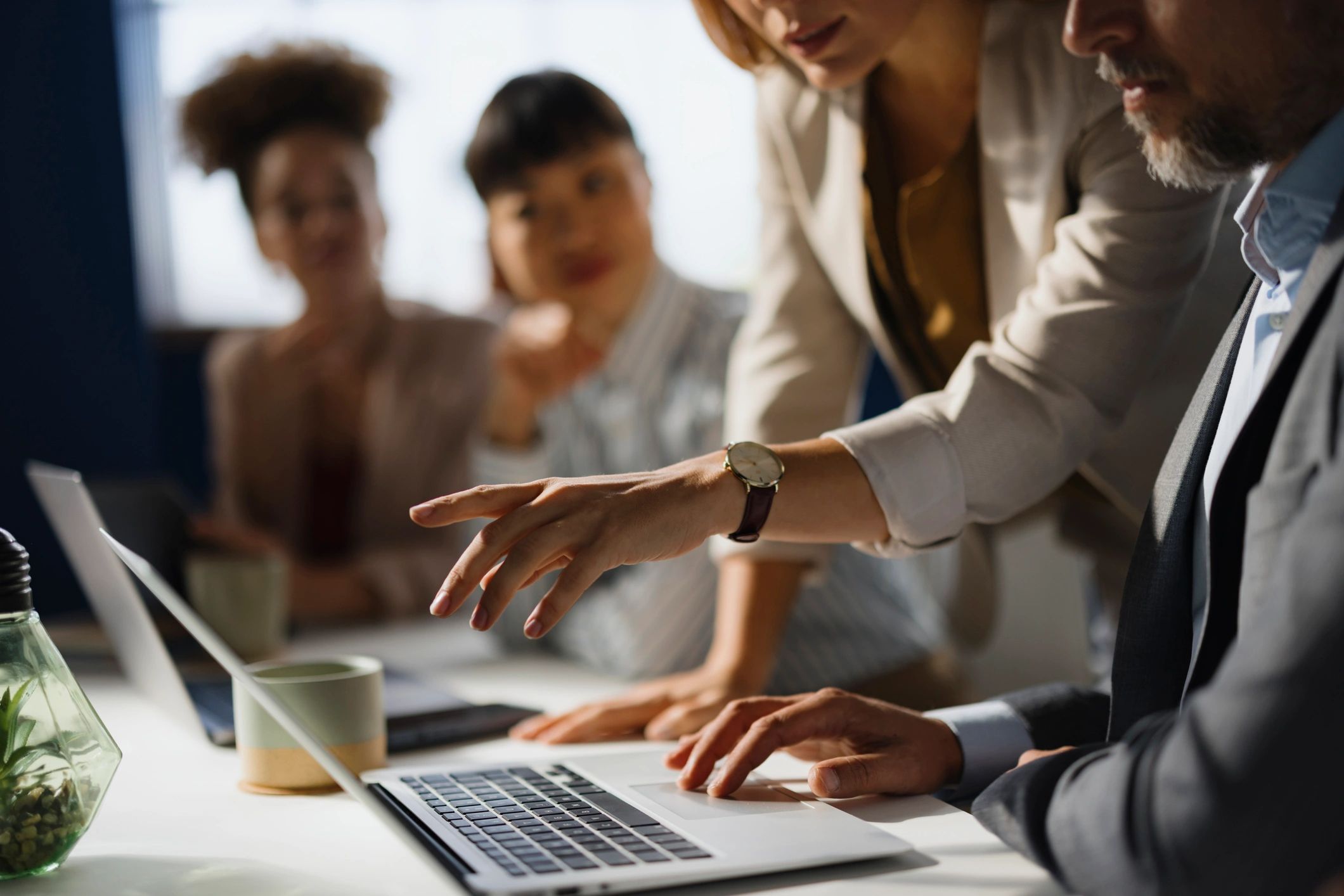 Marketing team reviewing an email on a laptop