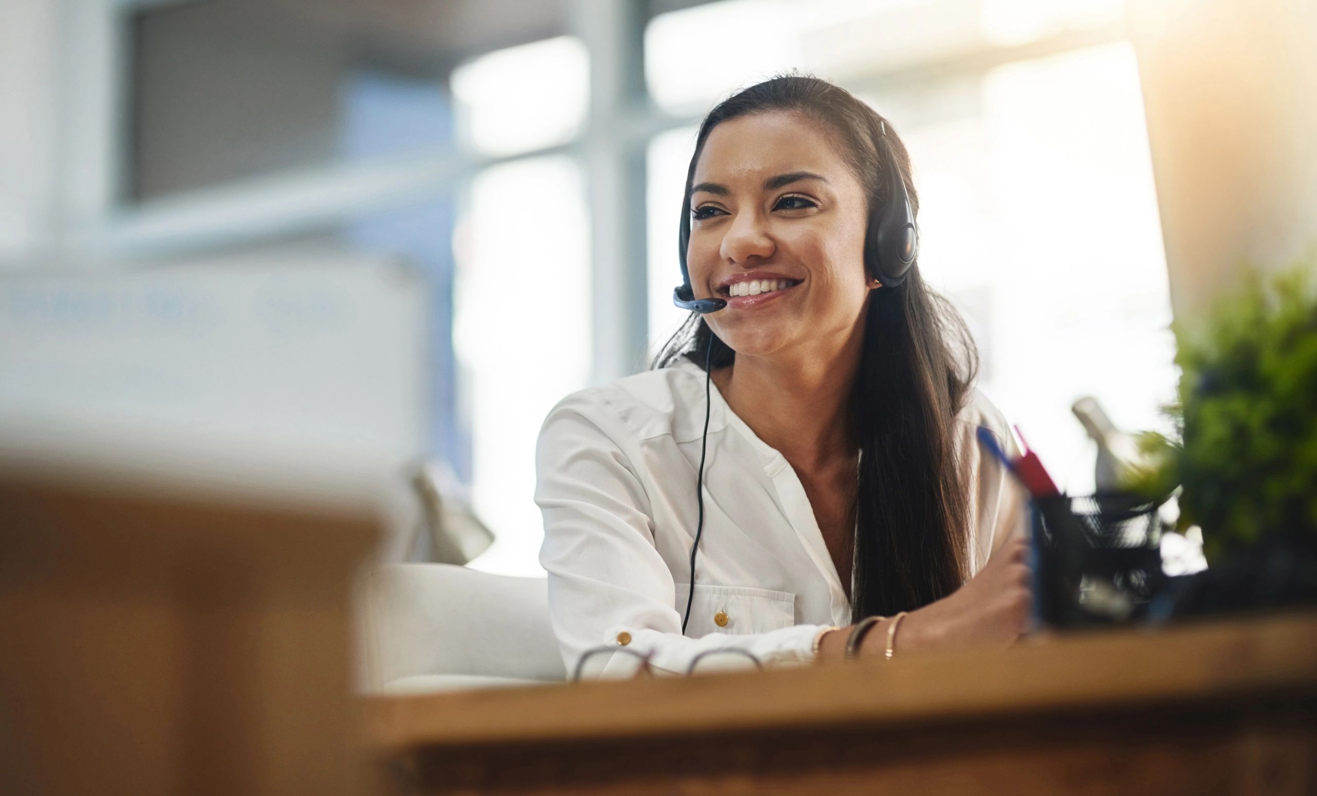 Professional portrait of a customer service representative at a desk